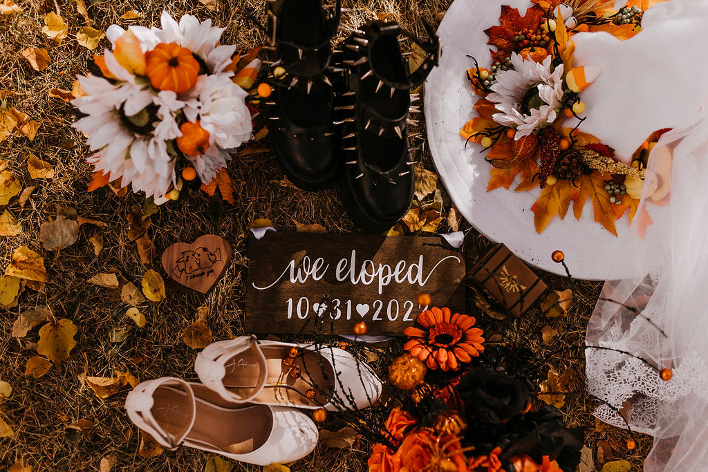 Elopement decorations on the ground with autumn leaves and flowers