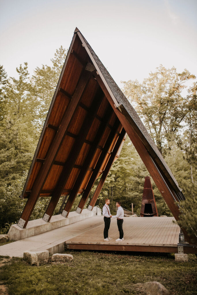 Couple eloping under an A-frame.